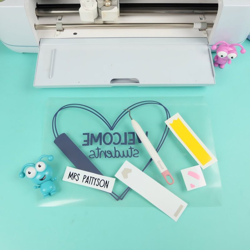 Cricut Maker 3 with weeded vinyl and htv for sign.