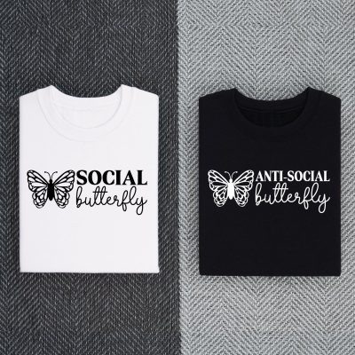 Two shirts. One white that says Social Butterfly and one black that says Anti-Social Butterfly