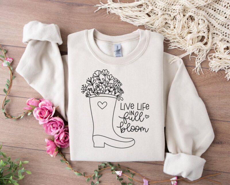 Live Life In Full Bloom sweatshirt with rain boot filled with wildflowers.