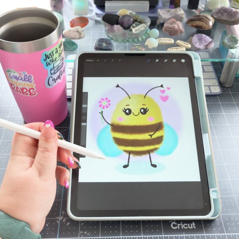 Crystal Allen from Hello Creative Family drawing a bee on her ipad with an apple pencil. 