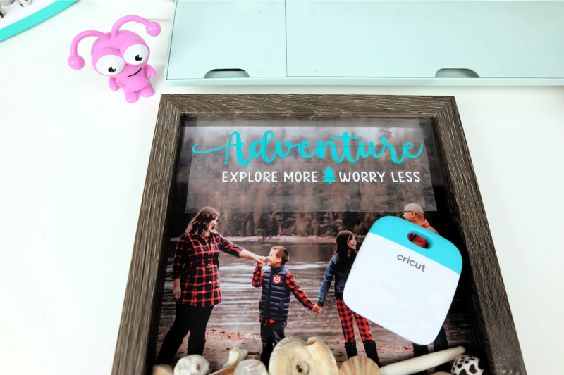Transferring a vinyl design to a picture frame using transfer tape.