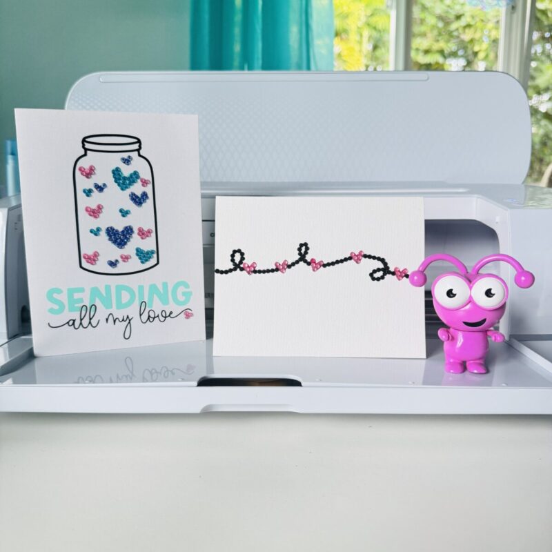 Two Rhinestone Cards sitting in front of a Cricut cutting machine