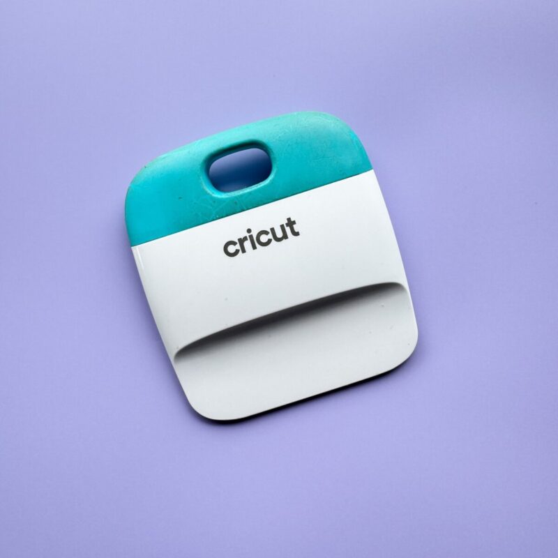 Cricut scraper tool on purple background
