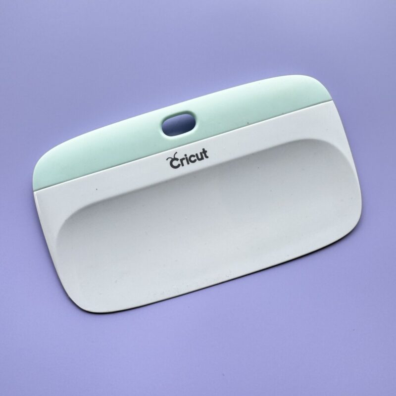 Cricut XL Scraper tool on purple background