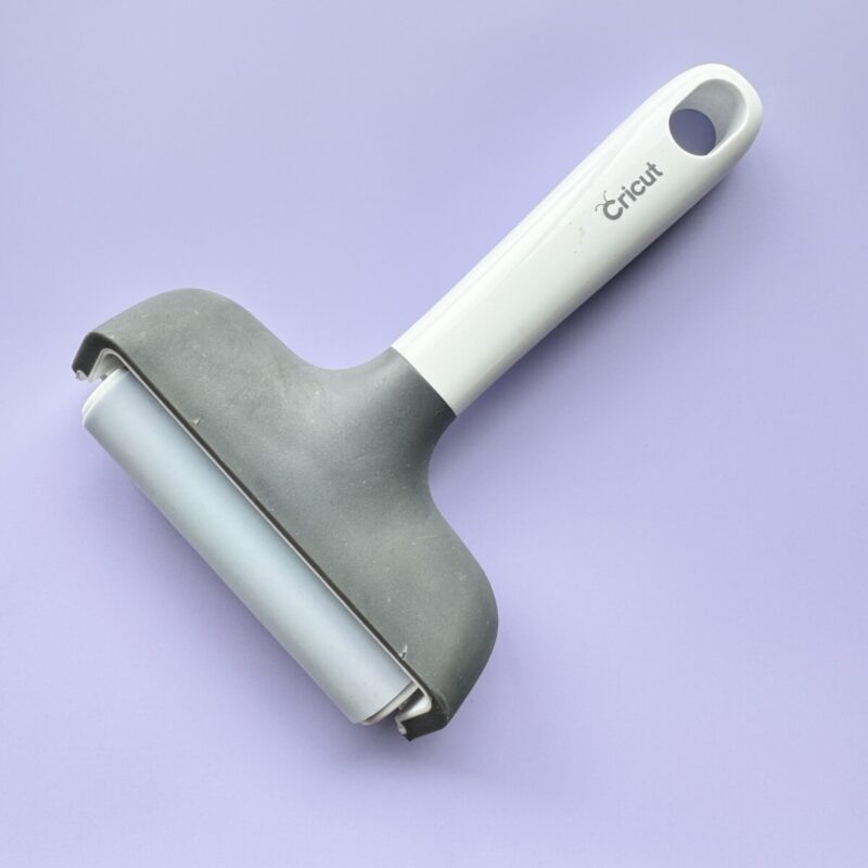 Cricut brayer tool on purple background