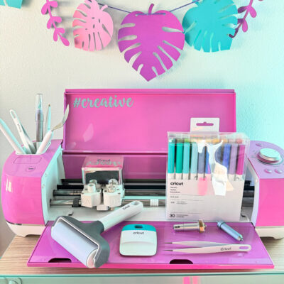 Cricut tools sitting in front of a pink Cricut Explore