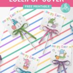 Easter Basket Printable: Free Printable Easter Tags for Lollipops- Adorable Easter Gnome Lollipop Covers with lollipops laying on top of piece of scrapbook paper with pastel stripes.