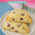 Two scones sitting on a white plate with a blue towel and pink flowers. 20 Minute Start To Finish Scone Recipe for Two... or One