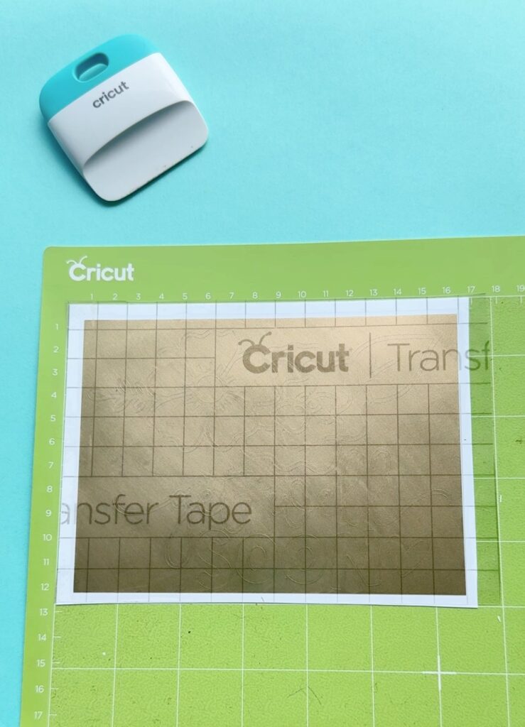 Burnish well using a scraper (the XL one is great for large designs). Then flip your "sandwich" over on your mat so that the transfer tape is now on the bottom, the vinyl decal in the middle and the vinyl backing is on top. Burnish again.