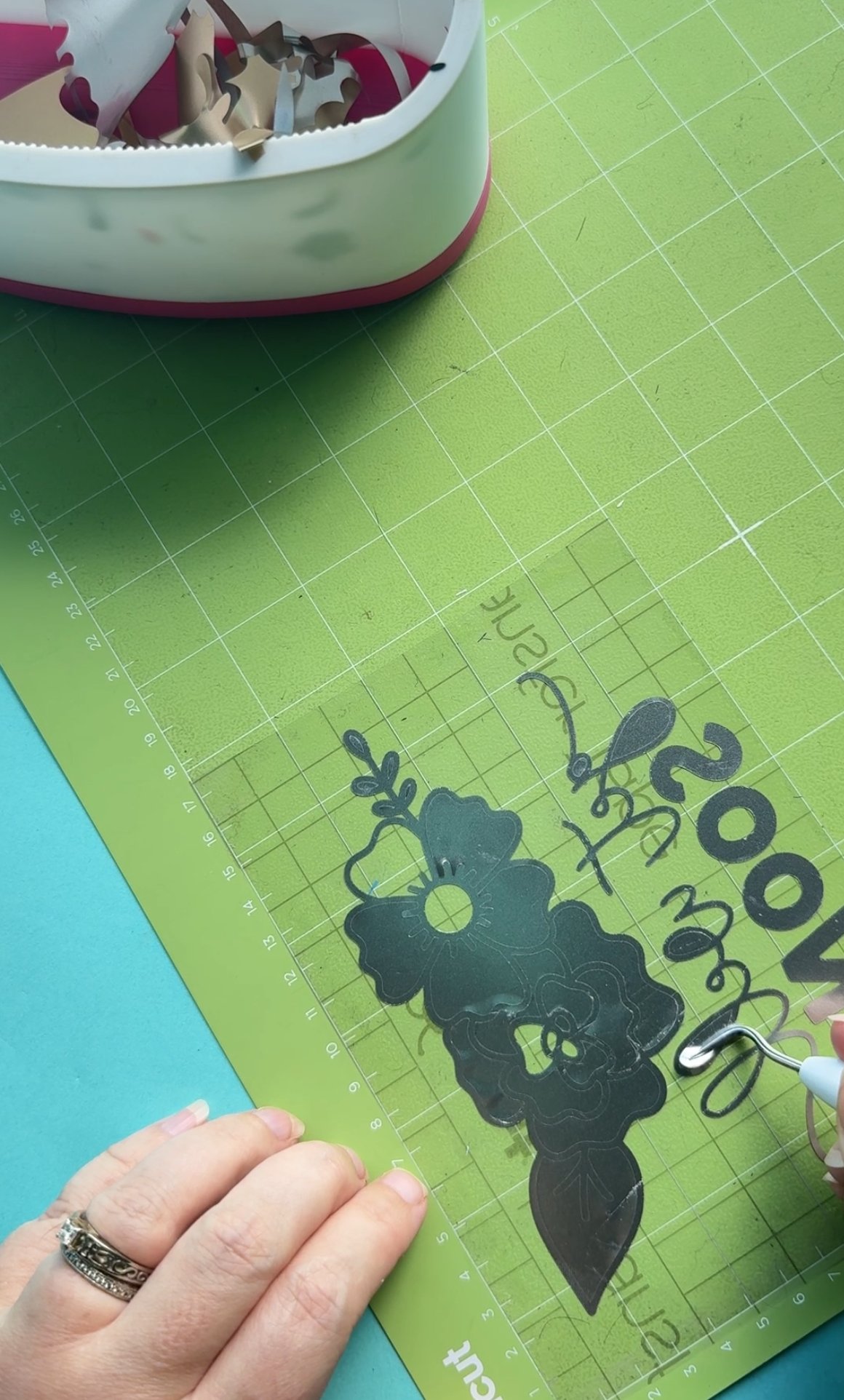 Once you have completely removed the vinyl backing, begin weeding on top of the transfer tape, removing the negative space and leaving just your design behind on the transfer tape.