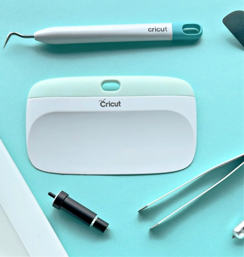 Cricut tools on blue background