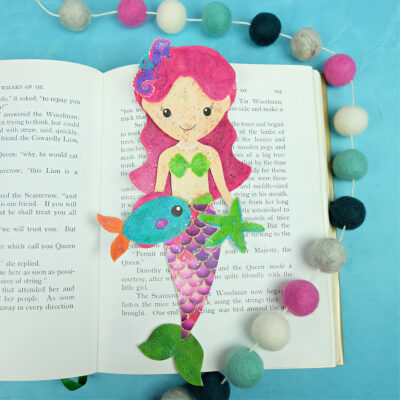 Looking for a fun mermaid craft with kids? Use our Free Sparkle Mermaid Bookmark Printable and easy step by step instructions for some easy crafting fun with kids! #MermaidCrafts #mermaids #Crafts #KidsCrafts #DIY #ModPodge #Printable #FreePrintable #MermaidPrintable