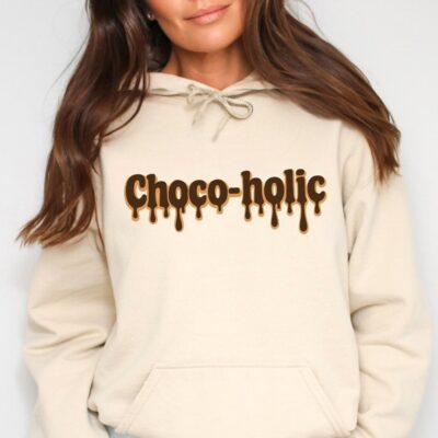 Cream-colored hoodie featuring the word “Choco-holic” in a dripping chocolate-style font.
