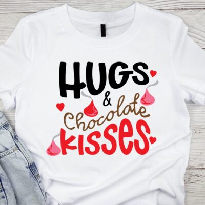 White t-shirt mockup with the phrase “Hugs & Chocolate Kisses” in red and brown lettering with chocolate kiss graphics.