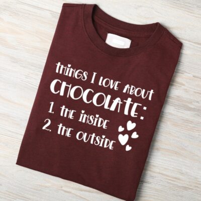 Folded brown t-shirt mockup listing “Things I love about chocolate: the inside, the outside” with heart accents.