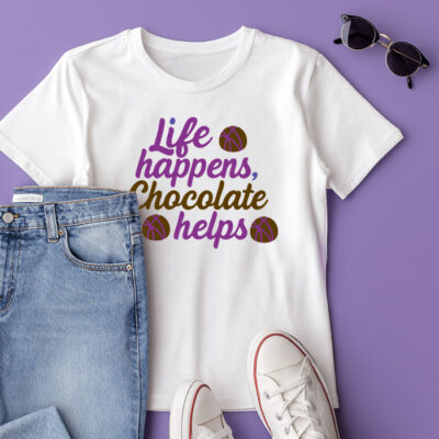 White t-shirt mockup with the phrase “Life happens, chocolate helps” styled with chocolate accents on a purple background.